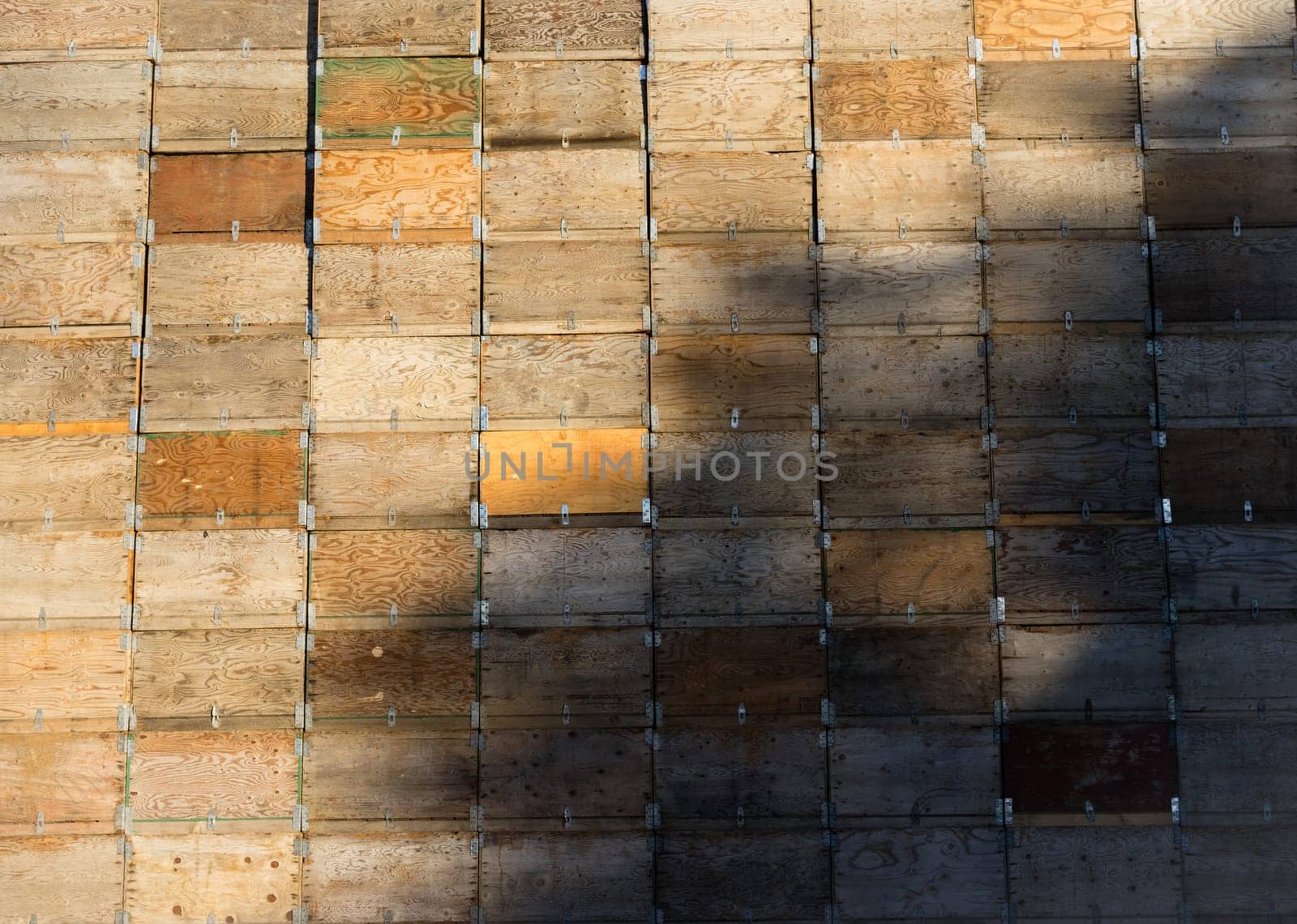 Fruit storage crates boxes are stacked unused before the farm harvest