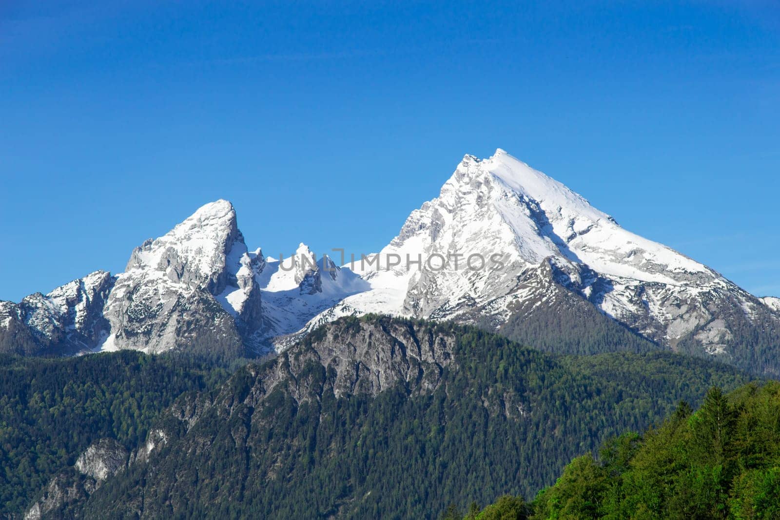 Snow-capped top mountain peaks of Watzmann Mount ridge in German Bavarian Alps. View to highland snowy landscape from high point in national park Berchtesgaden.