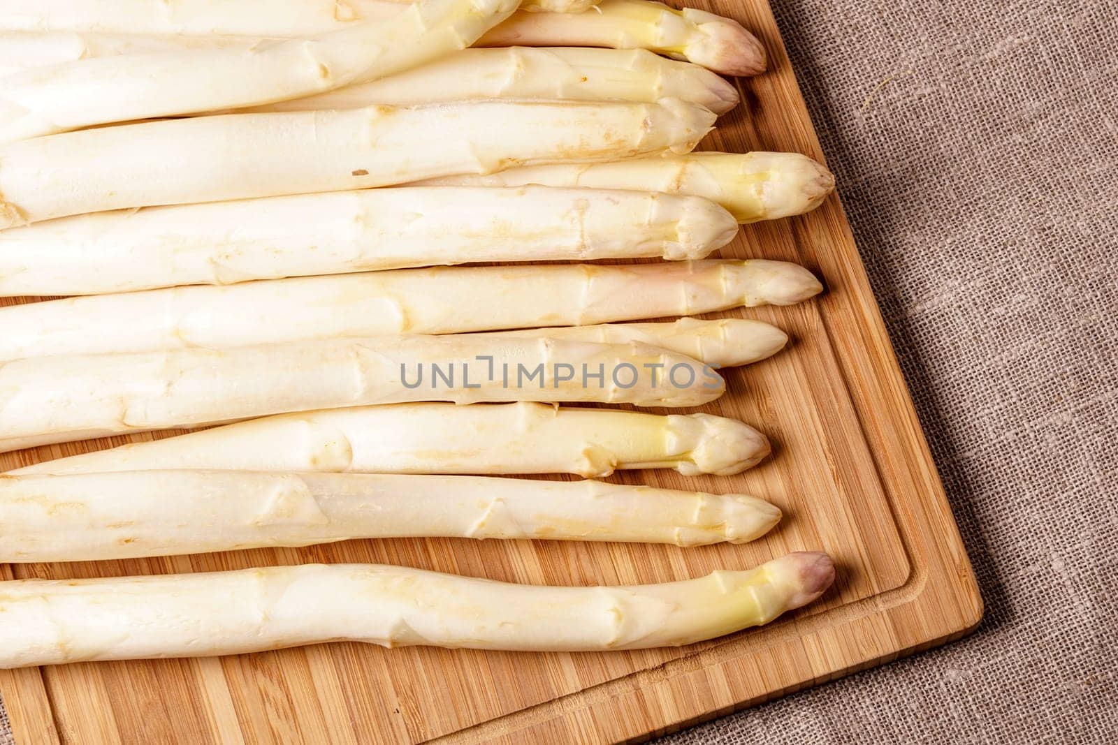 Delicate organic white asparagus ready to be peeled before they can be steamed