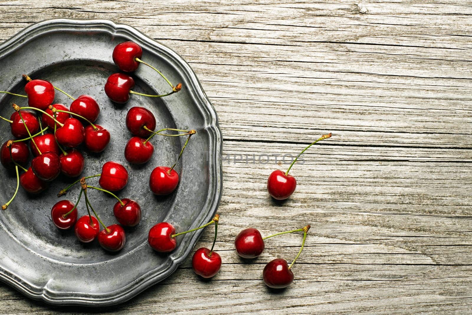 Fresh cherries on wooden table close up