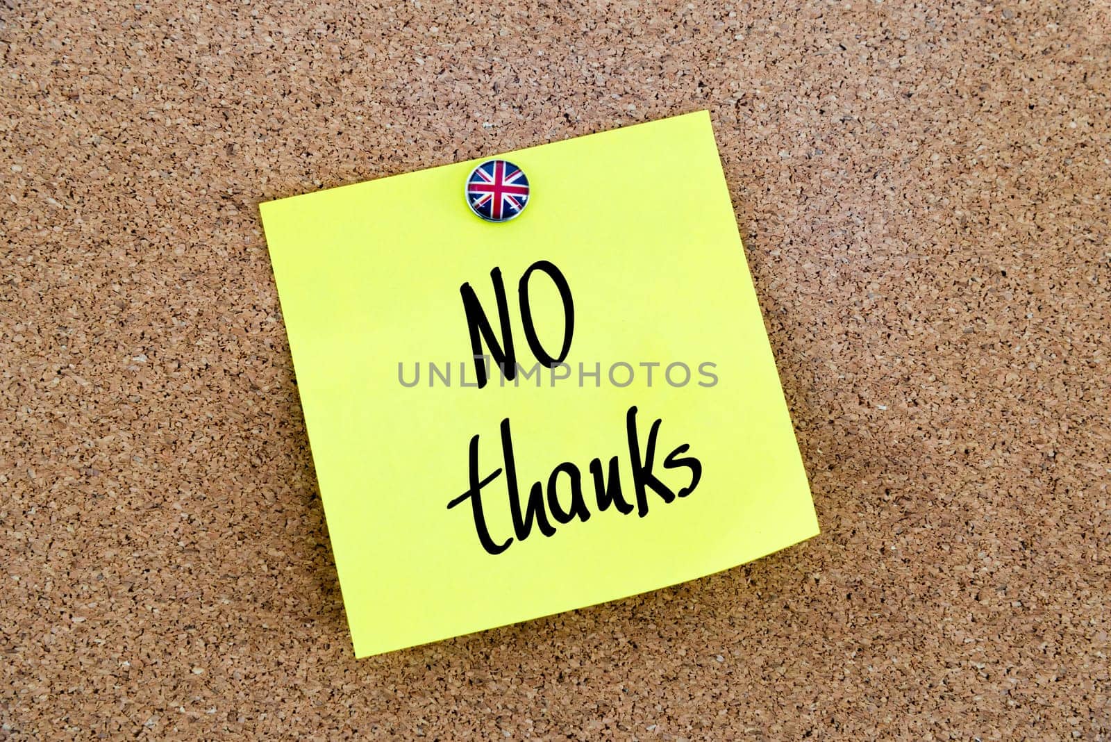 Yellow paper note pinned on cork board with Great Britain flag thumbtack, written text NO thanks, British Business concept