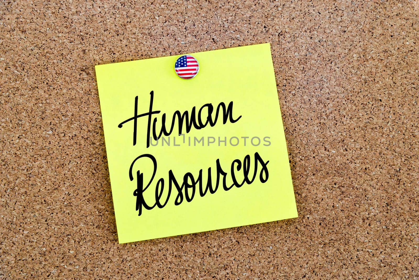 Written text Human Resources over yellow paper note pinned on cork board