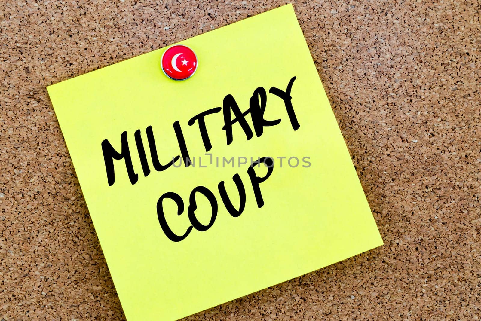 Written text Military Coup over yellow paper note pinned on cork board
