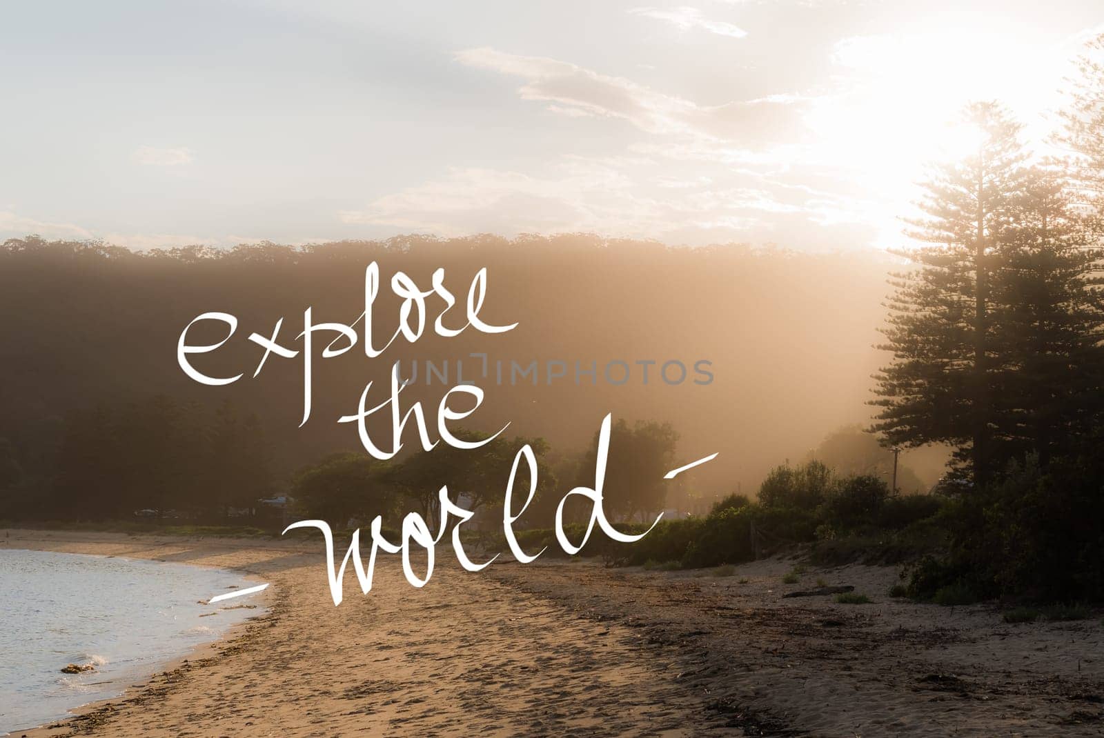 Explore The World message. Handwritten motivational text over sunset calm sunny beach background with vintage filter applied