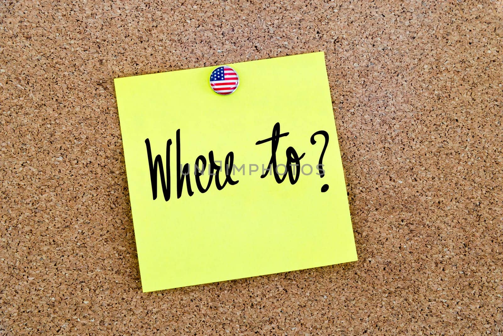 Written text Where To ? over yellow paper note pinned on cork board