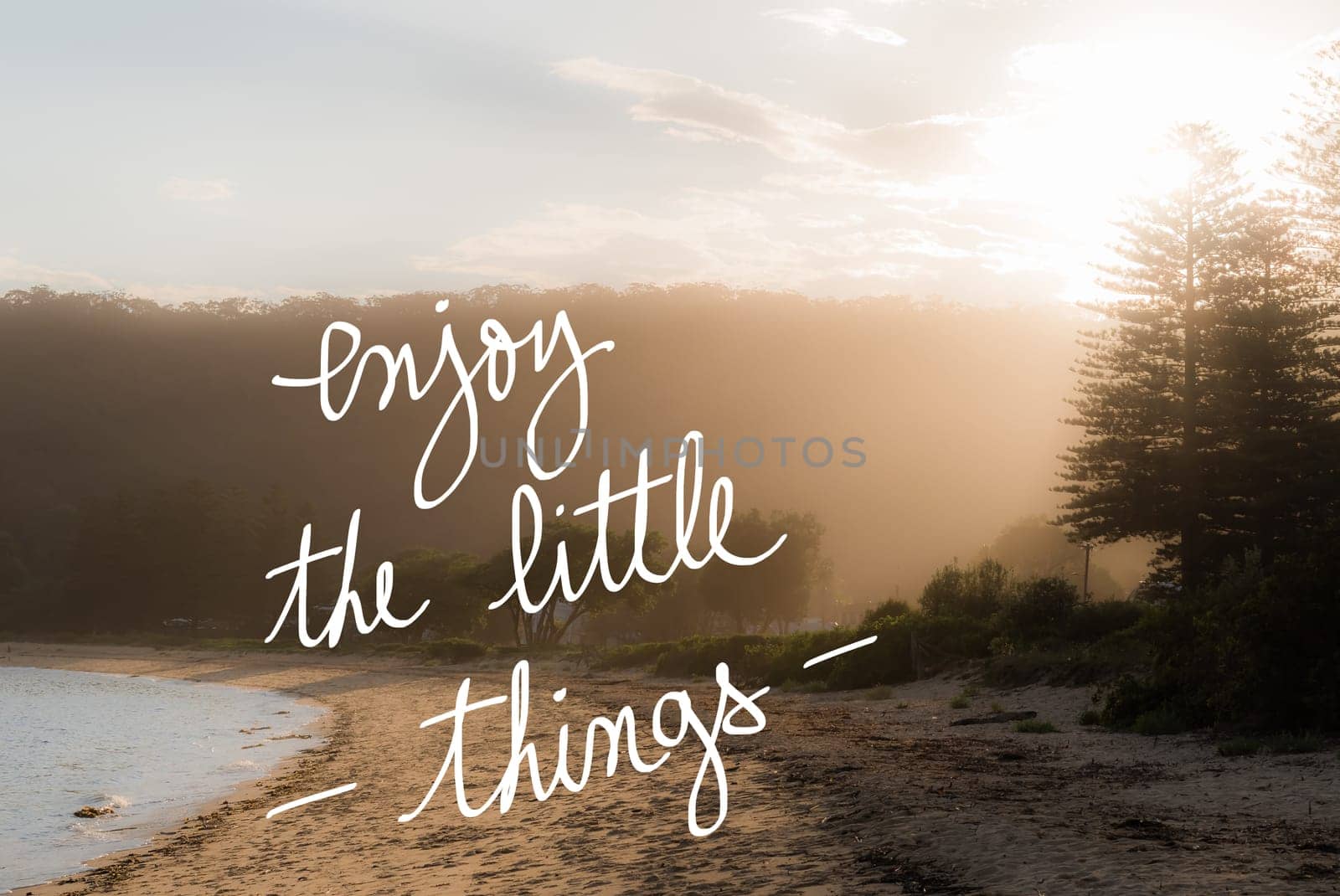 Enjoy The Little Things message. Handwritten motivational text over sunset calm sunny beach background with vintage filter applied