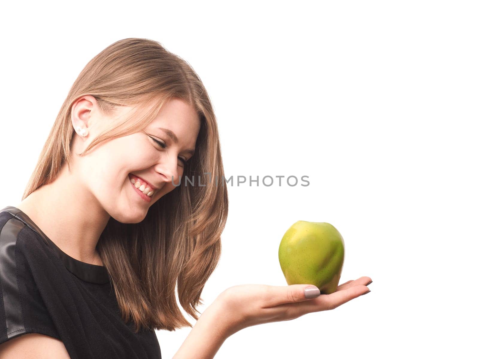 Young happy woman with a green apple on a white background
