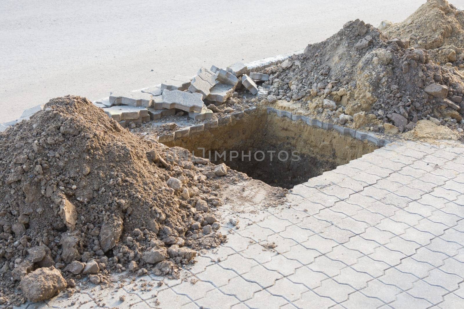 Dug a pit for planting trees on the pavement of paving slabs