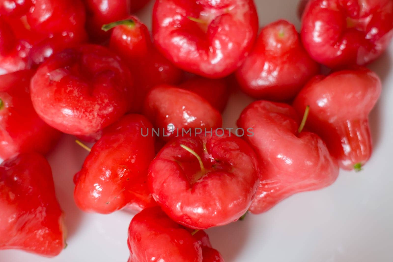 Mini rose apples on white table, stock photo