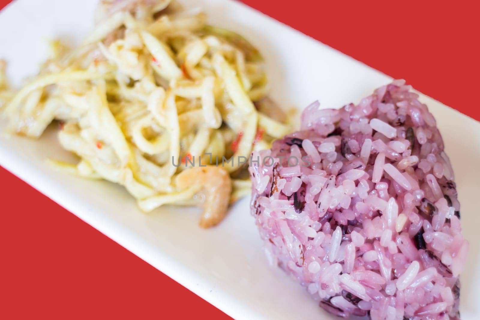 Spicy green mango salad with berry sticky rice, stock photo