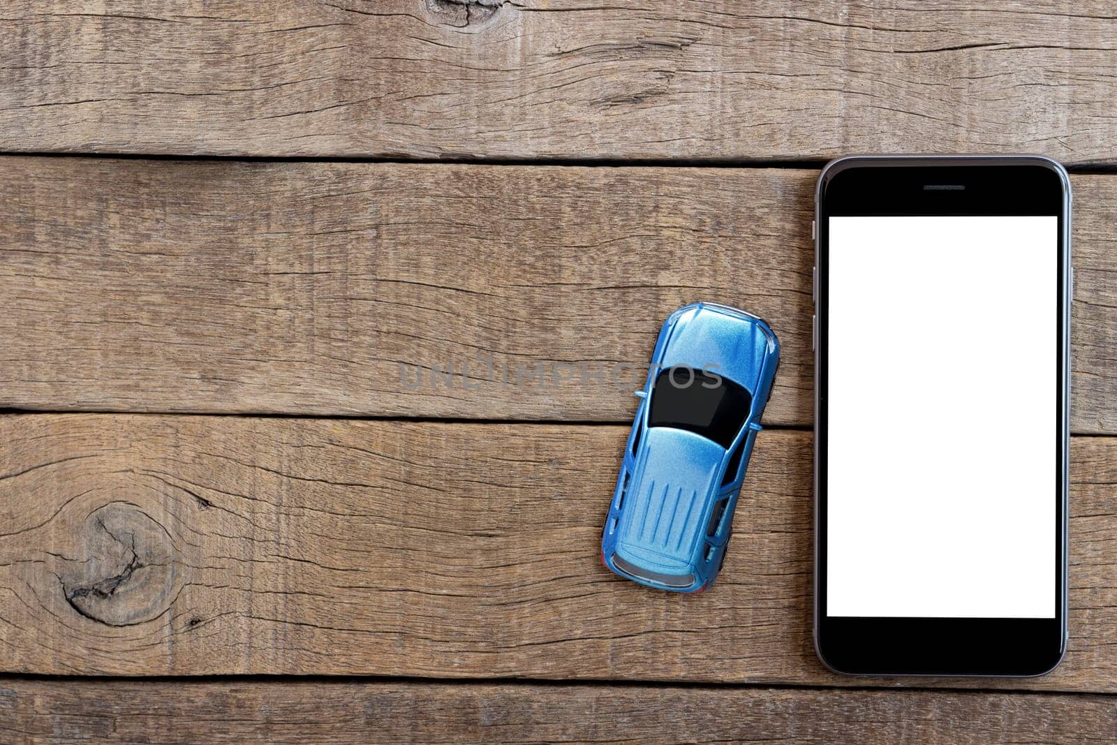 phone and car model toy on wood table top view