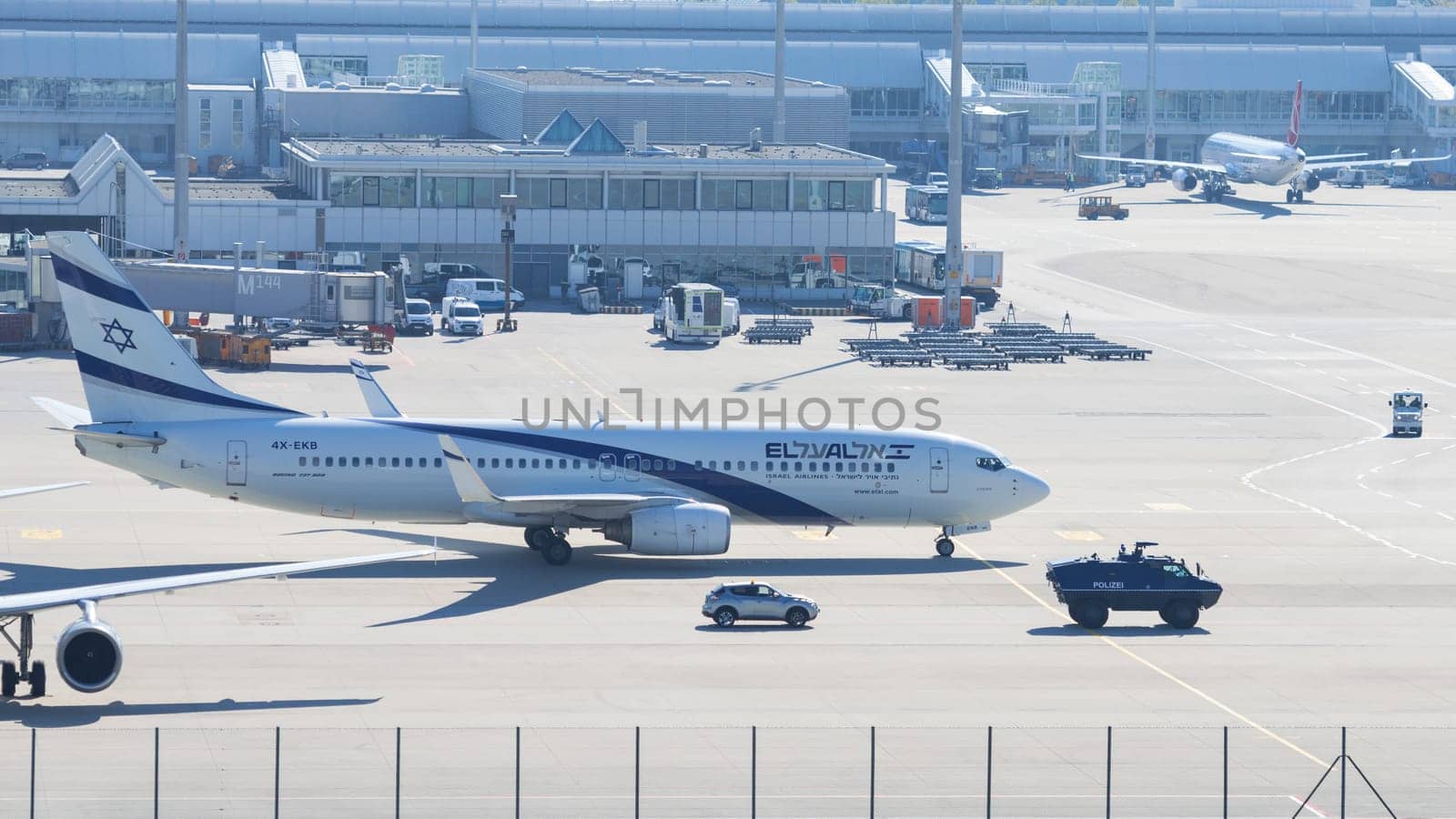 Munich, Germany - May 6, 2016: Armed police armored vehicle ensures antiterrorism attack defense measures for Israeli El-Al airliner in Munich international passenger airport.