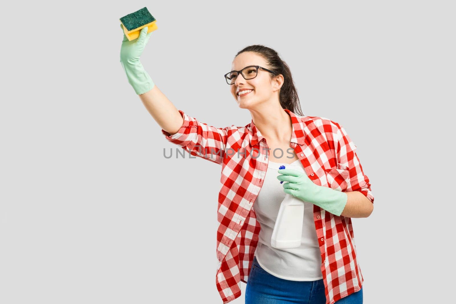 Woman portrait tired of cleaning, isolated over a gray background