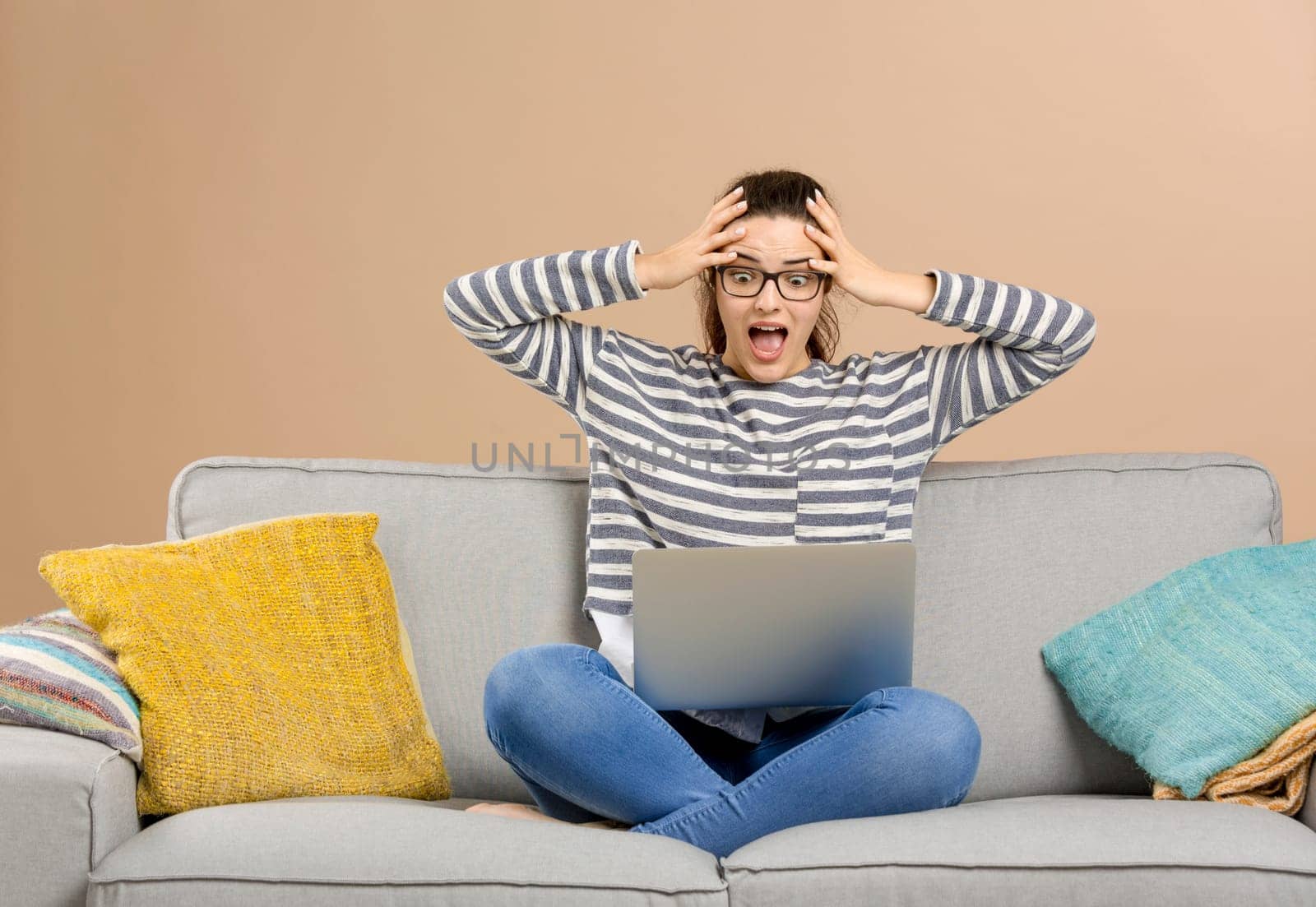 Stressed woman at home working with a laptop