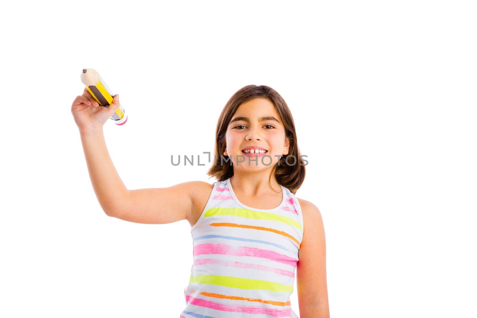 Little girl making a drawing with a big pencil in the floor