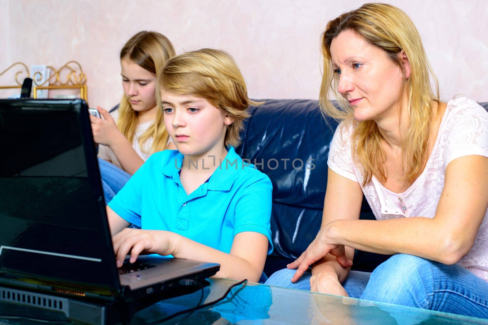 blond mother and her children using computer together