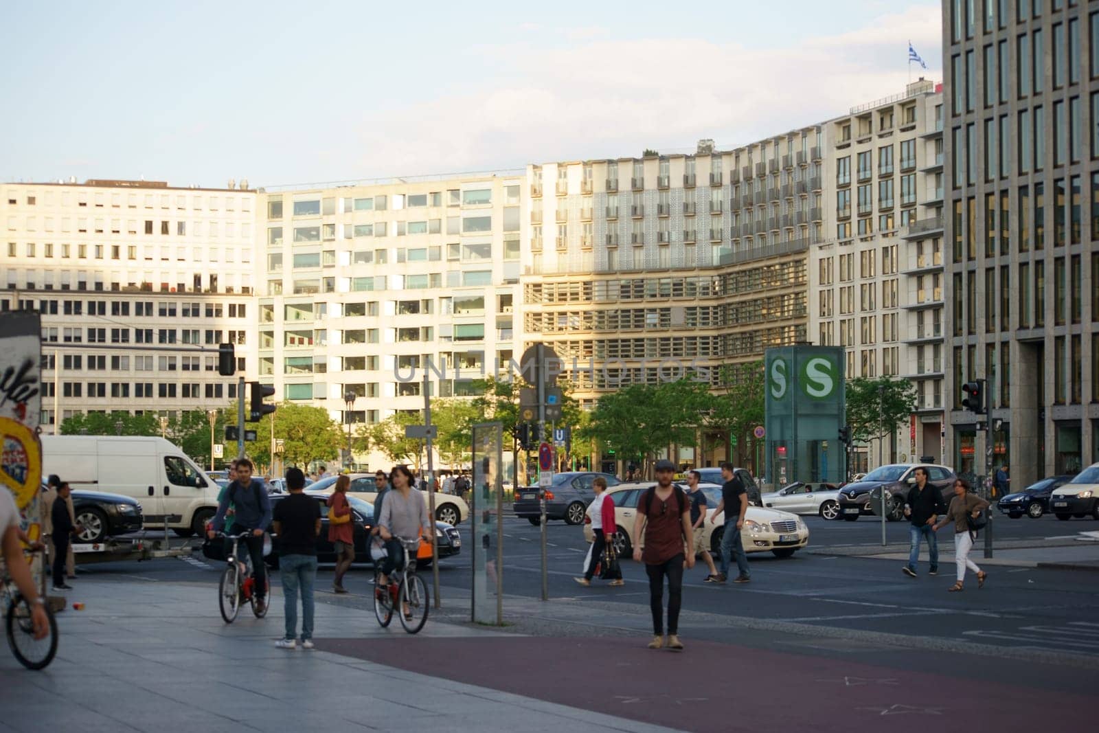 Berlin,Germany - May 10,2016: Road traffic,tourists and pedestrians at Potsdamer Platz opposite an S-Bahn station on May 10,2016 in Berlin.