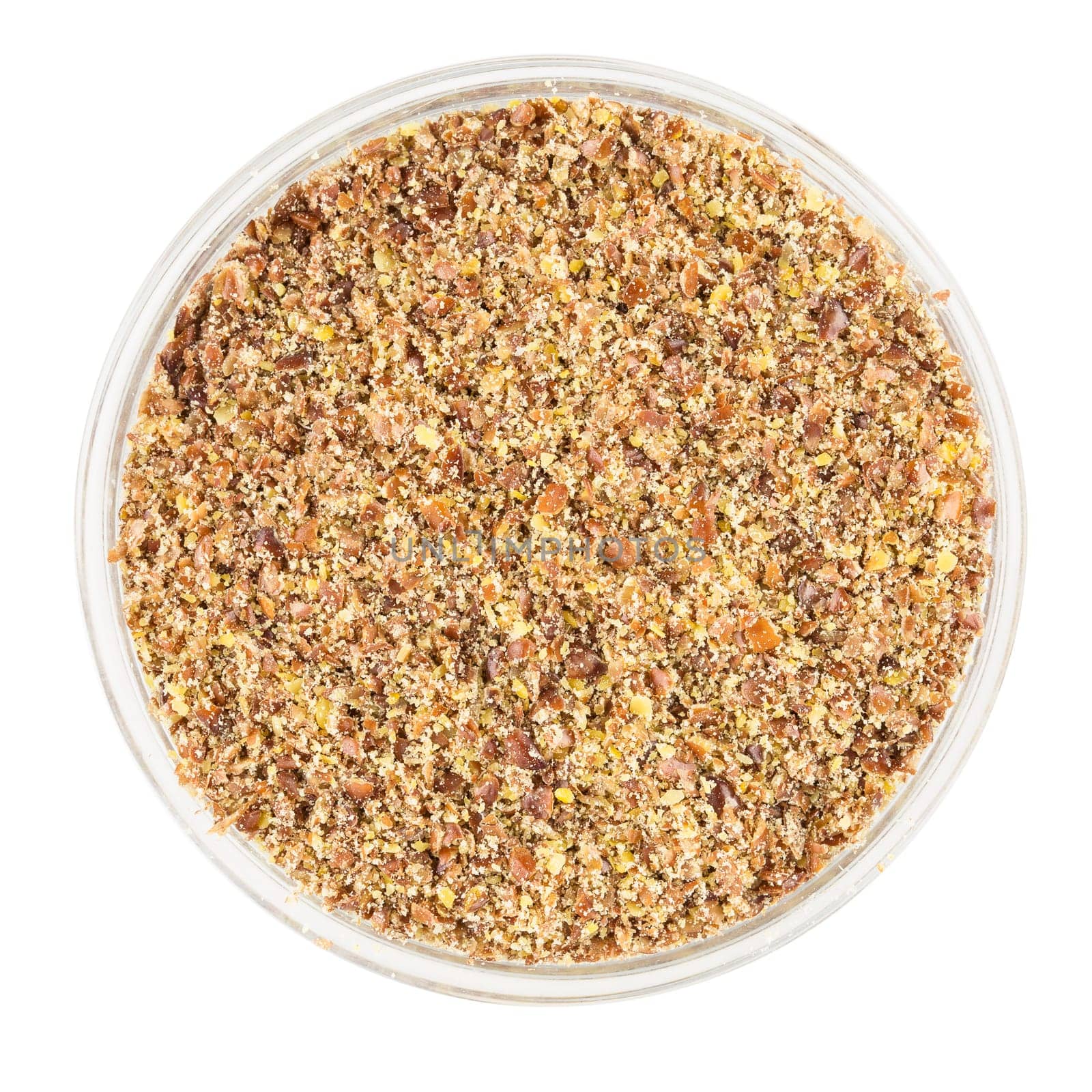 Bowl of ground flaxseeds or other nut, isolated on a white background