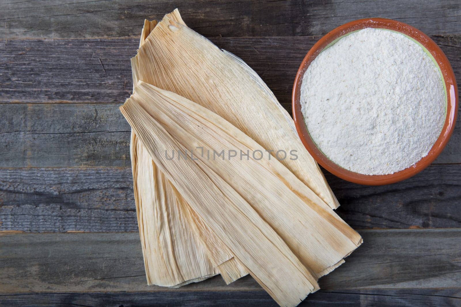 Corn masa flour and corn husks for preparing tamales.