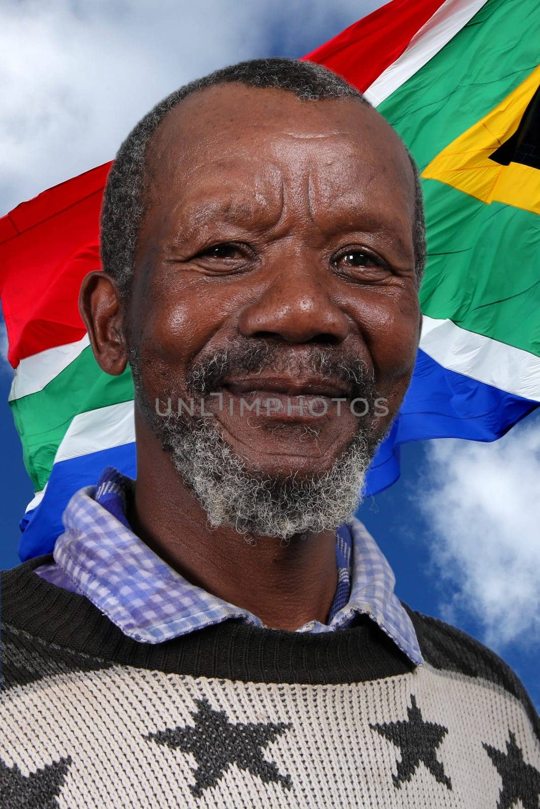 Portrait of a happy African man against the South African flag