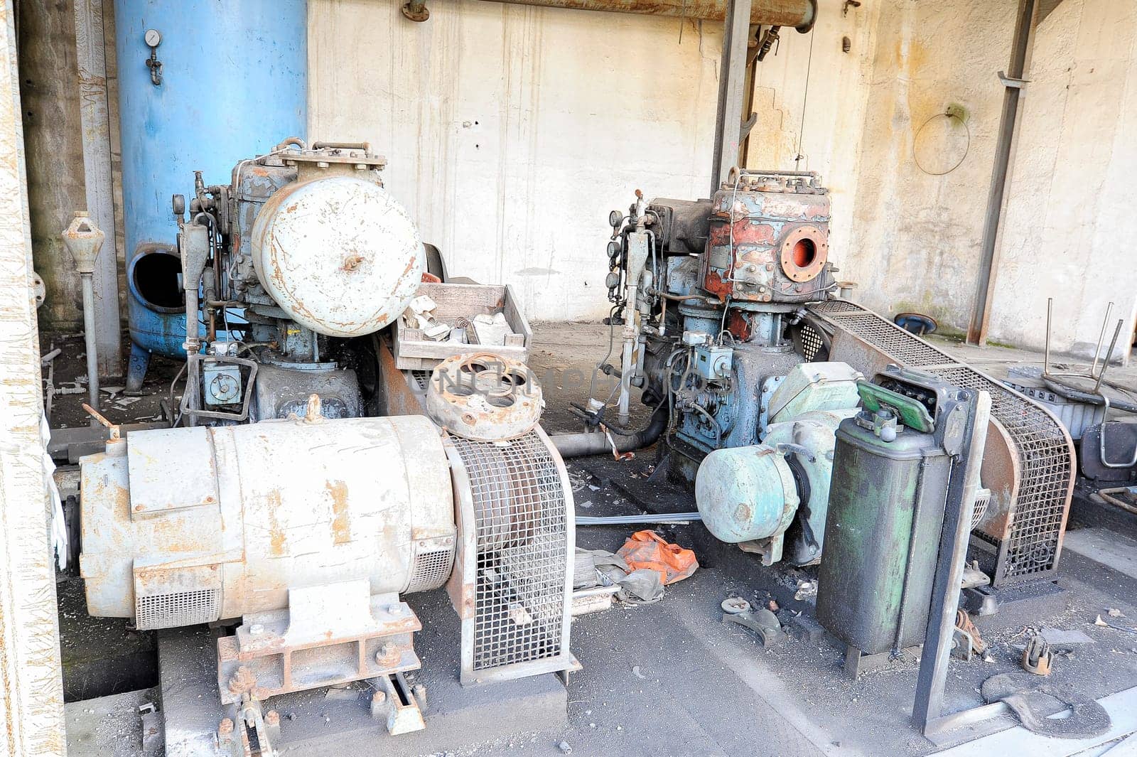 Old abandoned air compressor station, with two electric motor compressors.