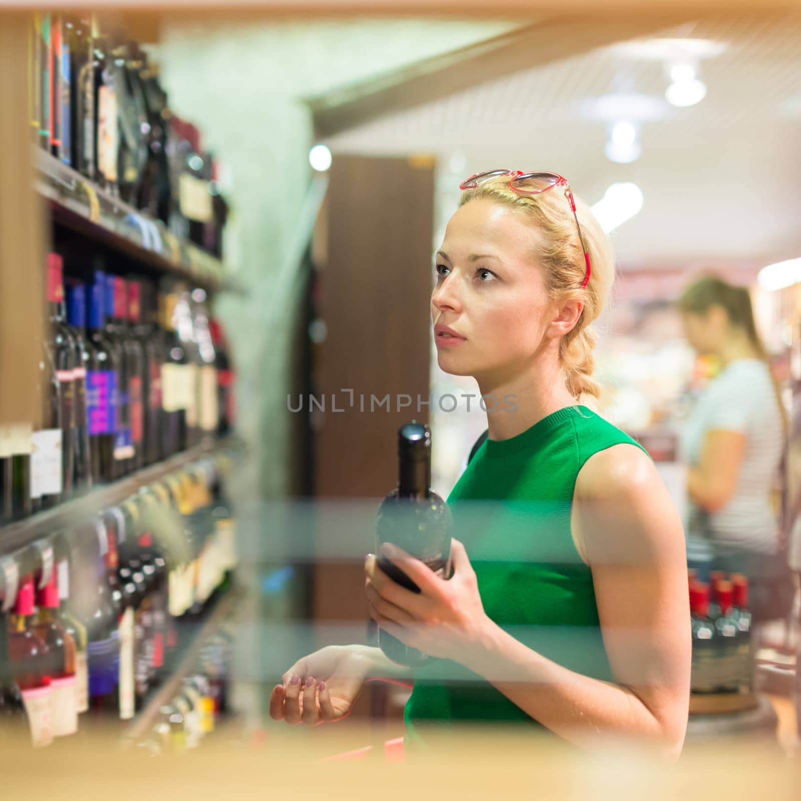 Beautiful caucasian woman shopping groceries at supermarket.