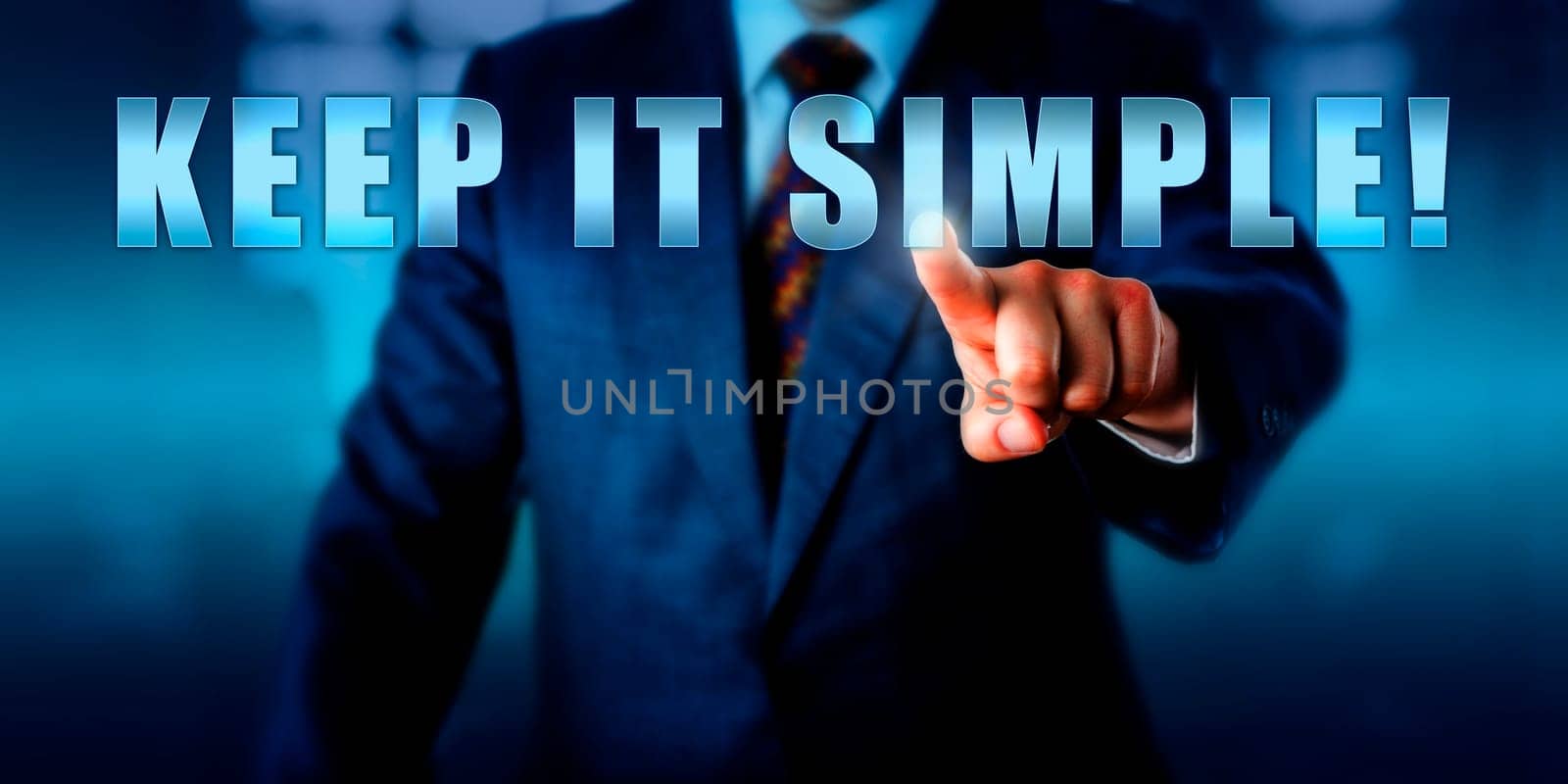 Business coach is pressing KEEP IT SIMPLE! on a virtual touch screen interface. Call to action, motivational appeal and business concept for a straight-forward tactical approach to management.