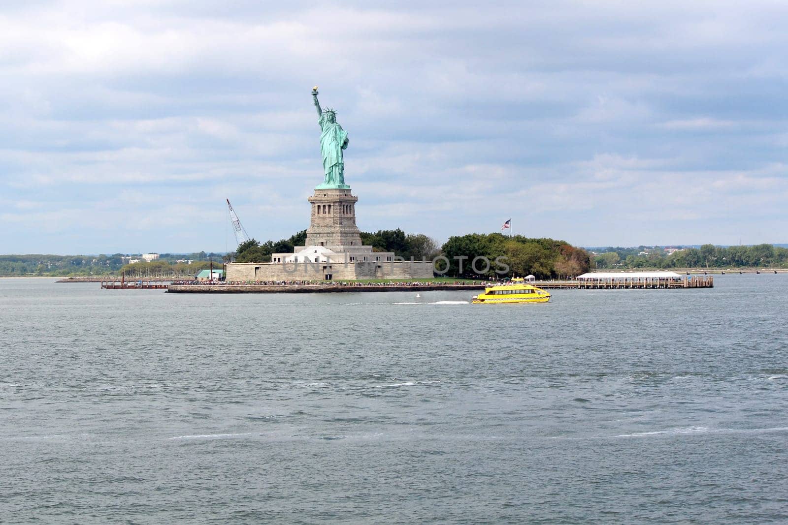 The Statue of Liberty (Liberty Enlightening the World), a colossal neoclassical sculpture on Liberty Island in the middle of New York Harbor, Manhattan. The statue is of a robed female figure representing Libertas, the Roman goddess of freedom, who bears a torch and a tabula ansata
