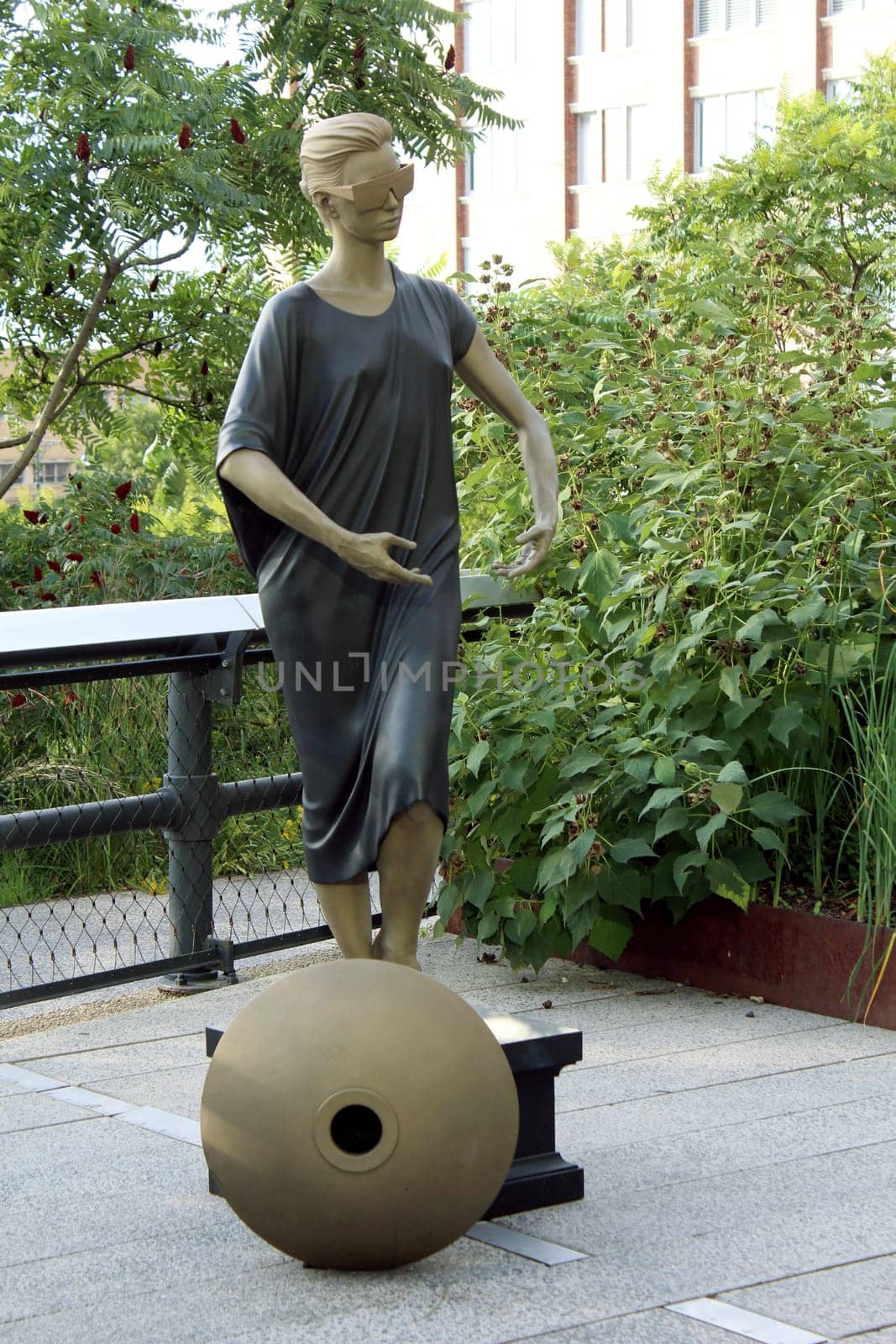 High Line statue. Elevated pedestrian Park and former elevated New York Central Railroad spur called the West Side Line, which runs along the lower west side of Manhattan  it has been redesigned and planted as an aerial greenway. New York City.