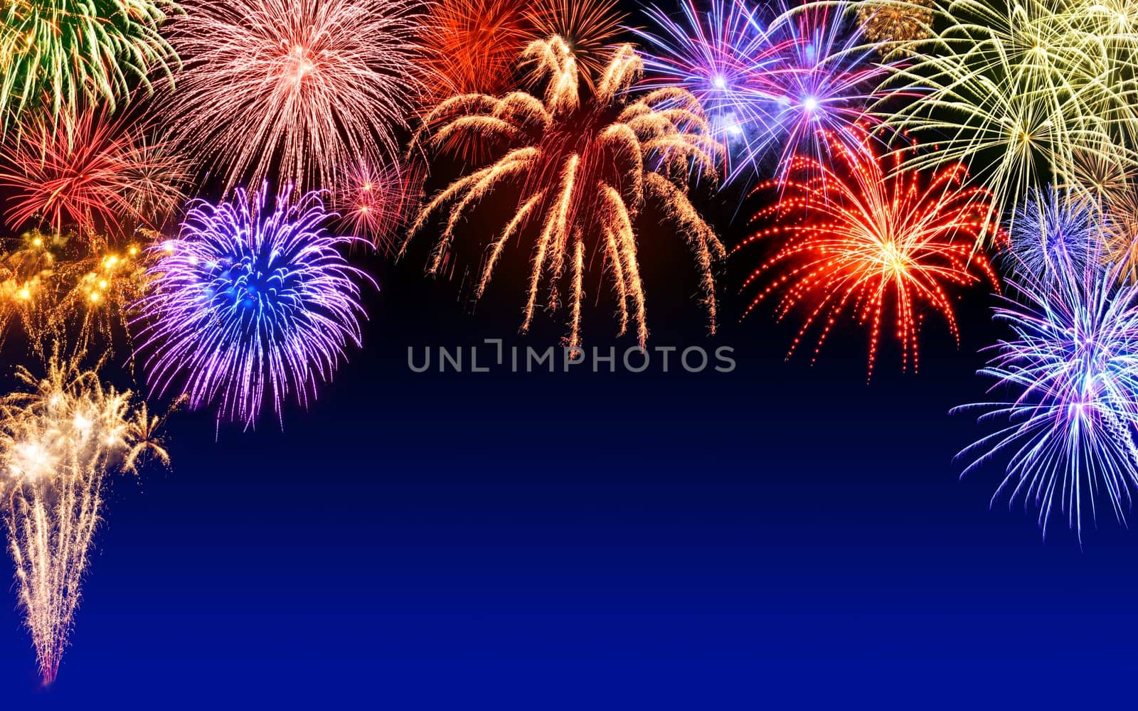 Atmospheric colourful fireworks on a dark blue night sky,with text-free space