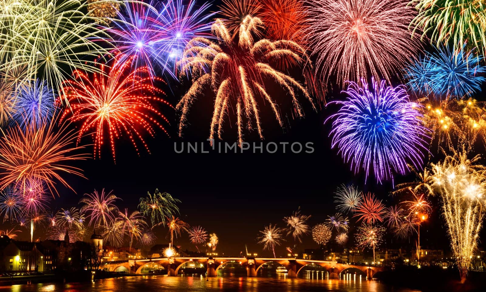 Lively big New Year's Eve fireworks in Heidelberg,with reflection on water