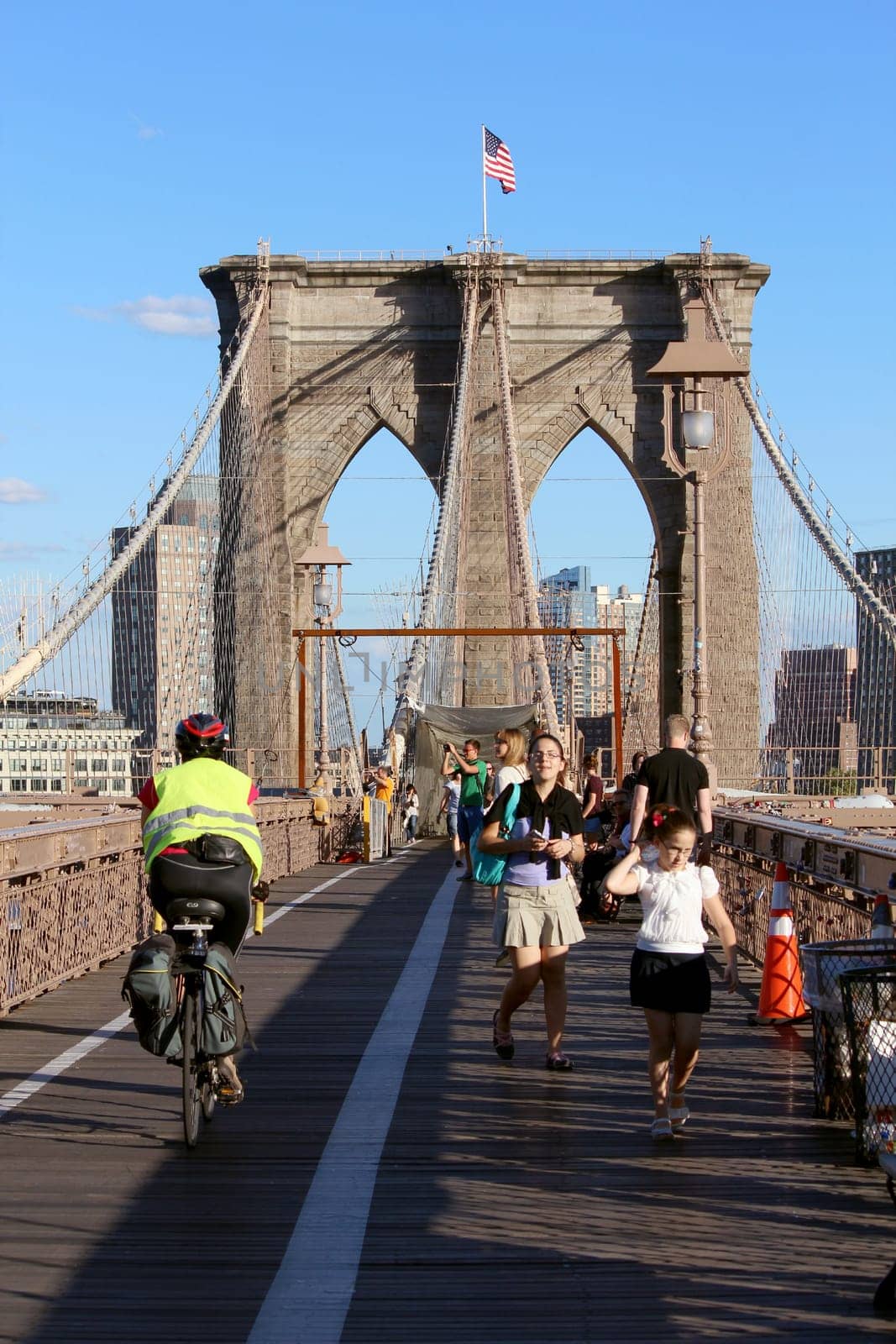 NEW YORK, SEPTEMBER 05: Pedestrians and tourists in Famous historic Brooklyn Bridge in Manhattan over Hudson River in September 05, 2013 in New York.