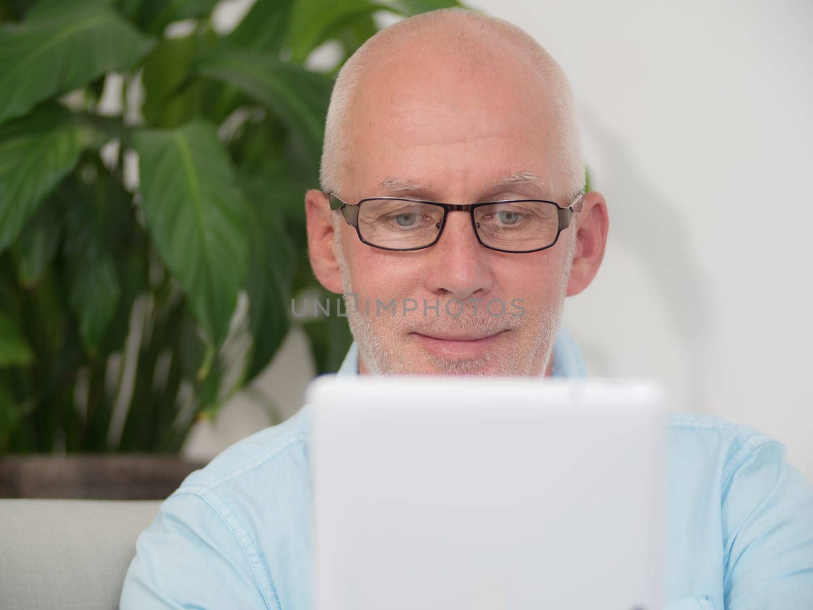 a portrait of a mature man with a tablet