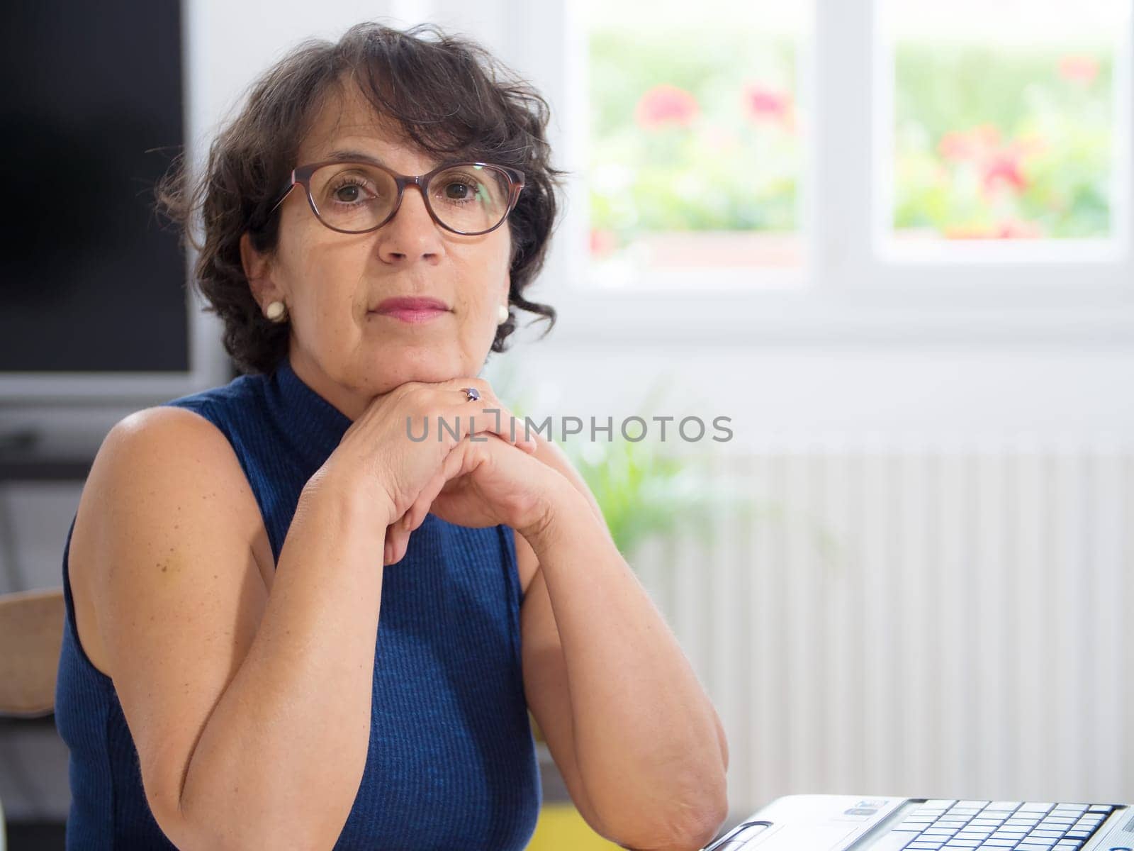 a portrait of a mature woman with glasses