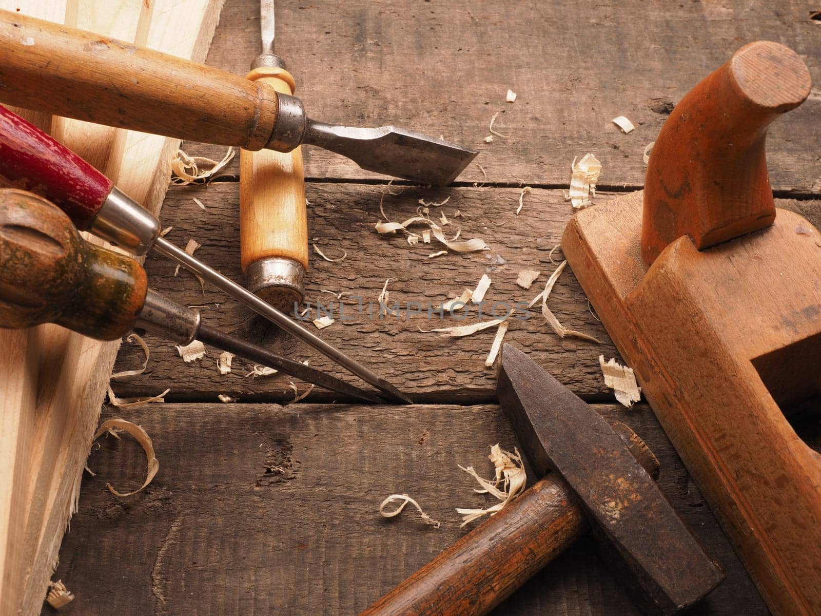 Old used carpenter tools on a workbench