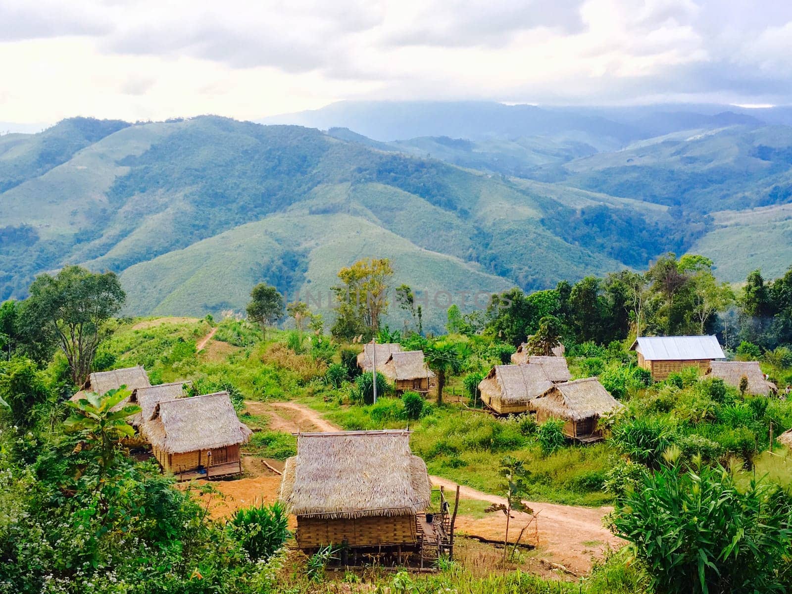 Local rural houses with mountains background in laos, asia.