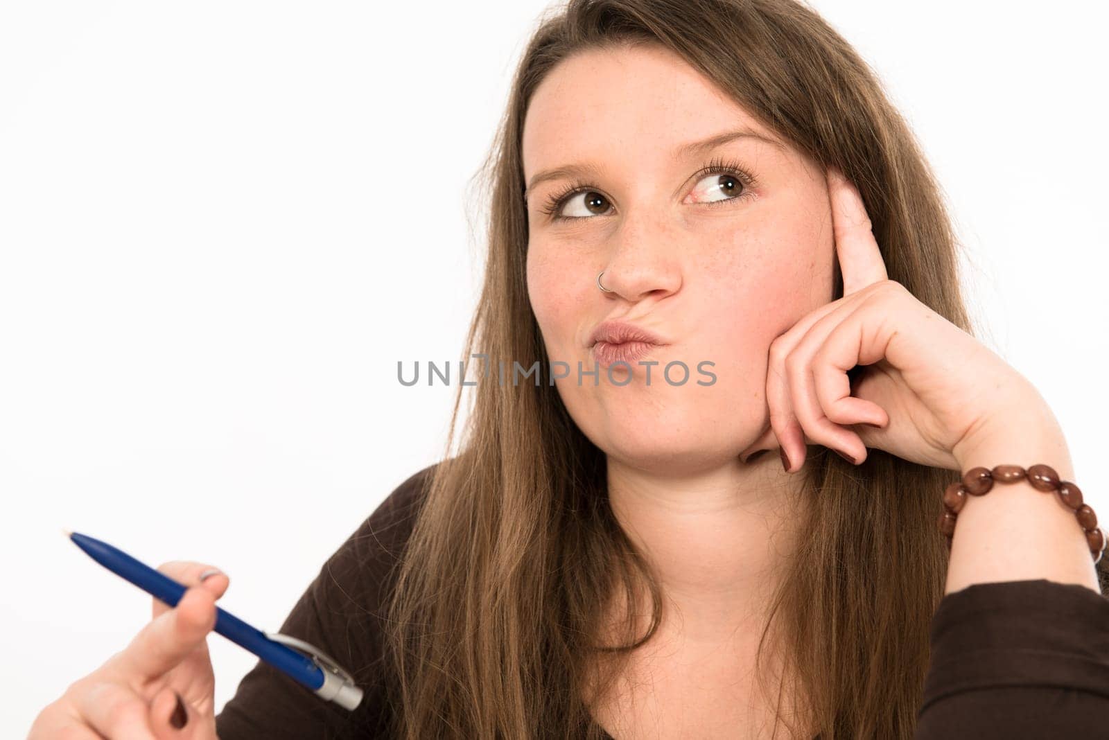 young woman in front of white background is reflecting