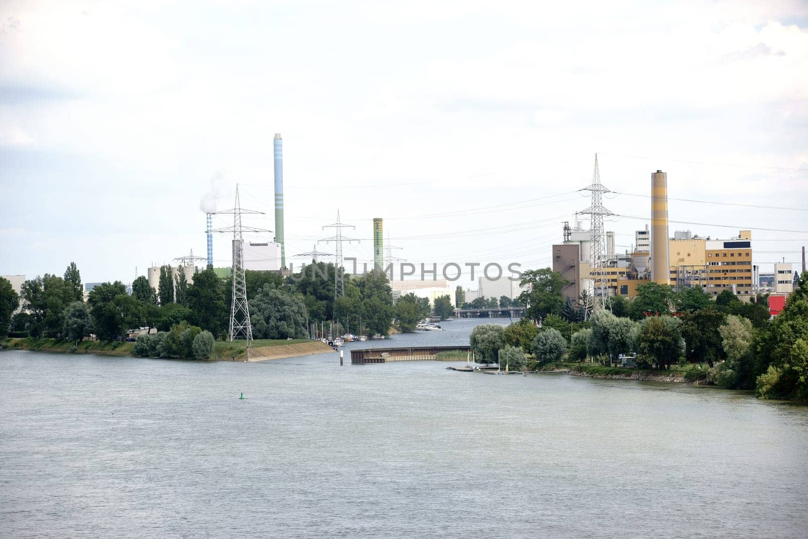 Various industrial plants and power plants located on a river.
