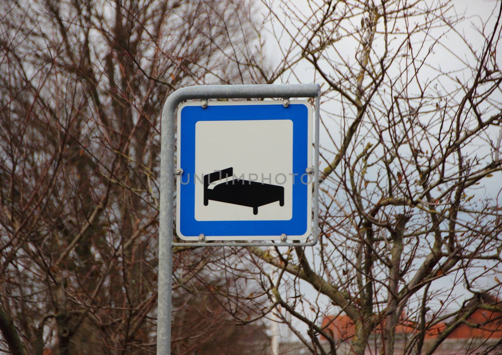 Road Hotel Sleeping Metal Sign Closeup in White and Blue