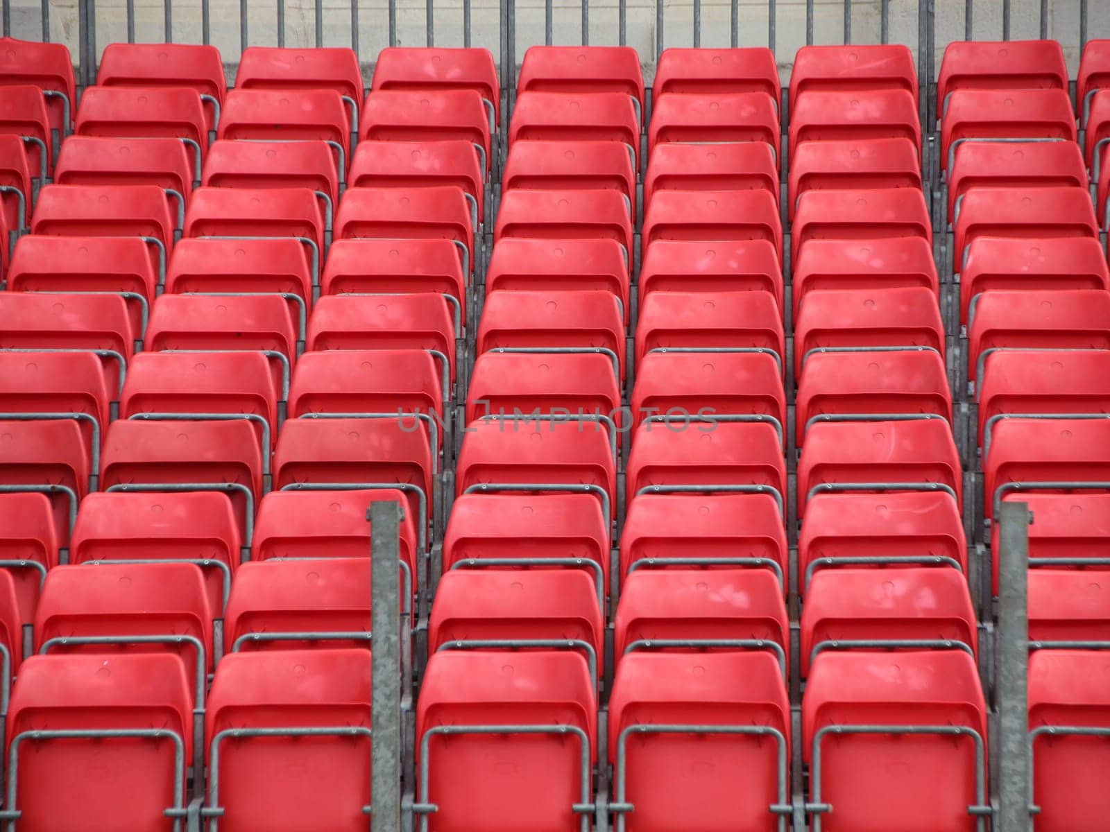 Closeup on Concert Spectator Steel Platform with Rows of Red Plastic Seats