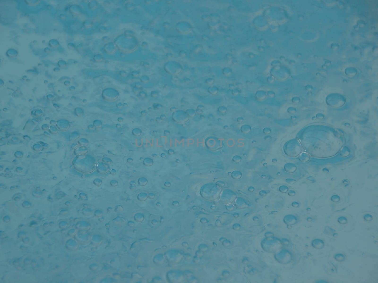 Perspective of Blue Swimming Pool Water Surface with Small Sparkling Bubbles
