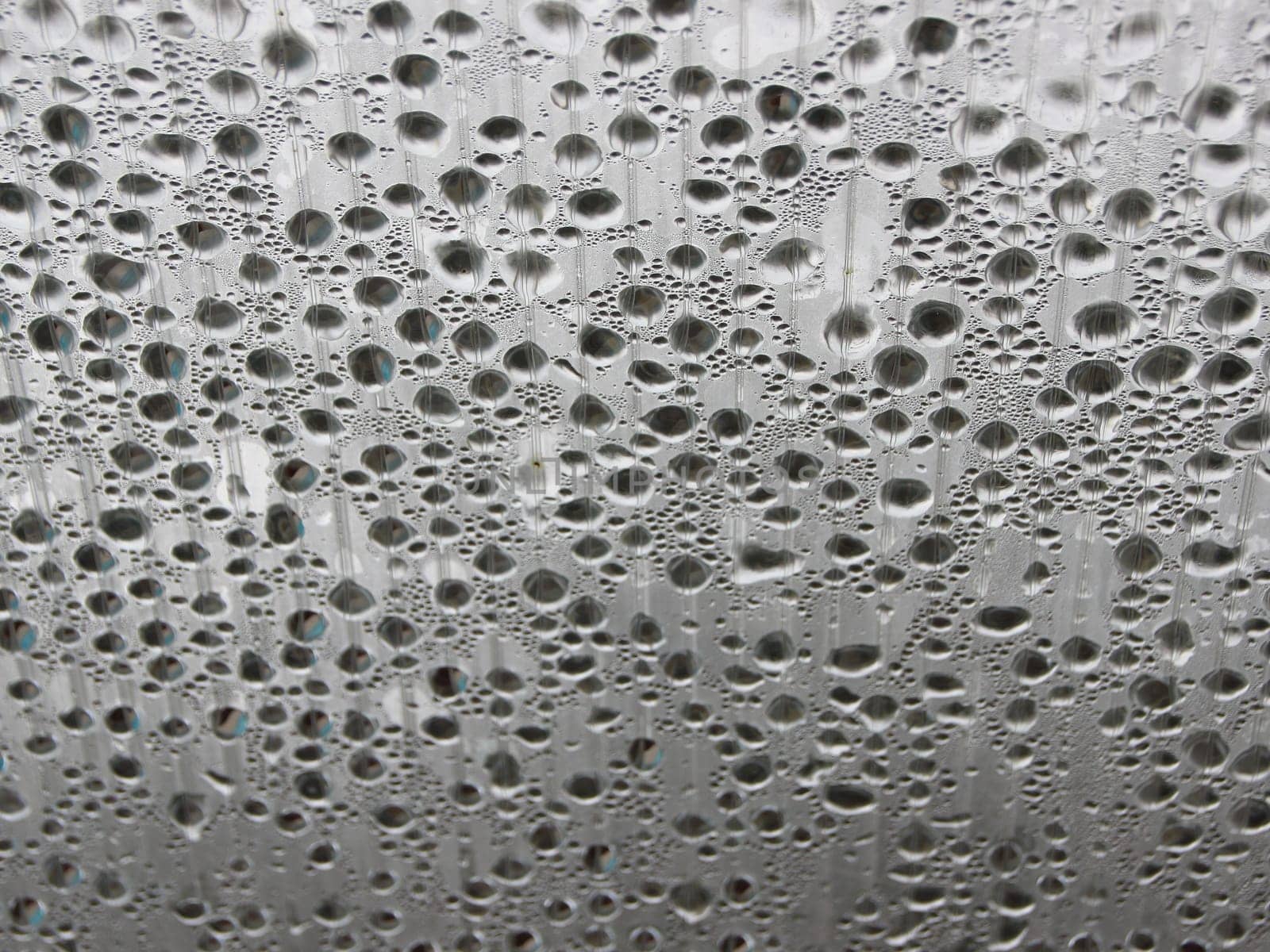 Water Damp Moisture Condensation under Striped Plastic Roof in a Small Outdoor Swimming Pool. Cold outside - but Warm Inside.