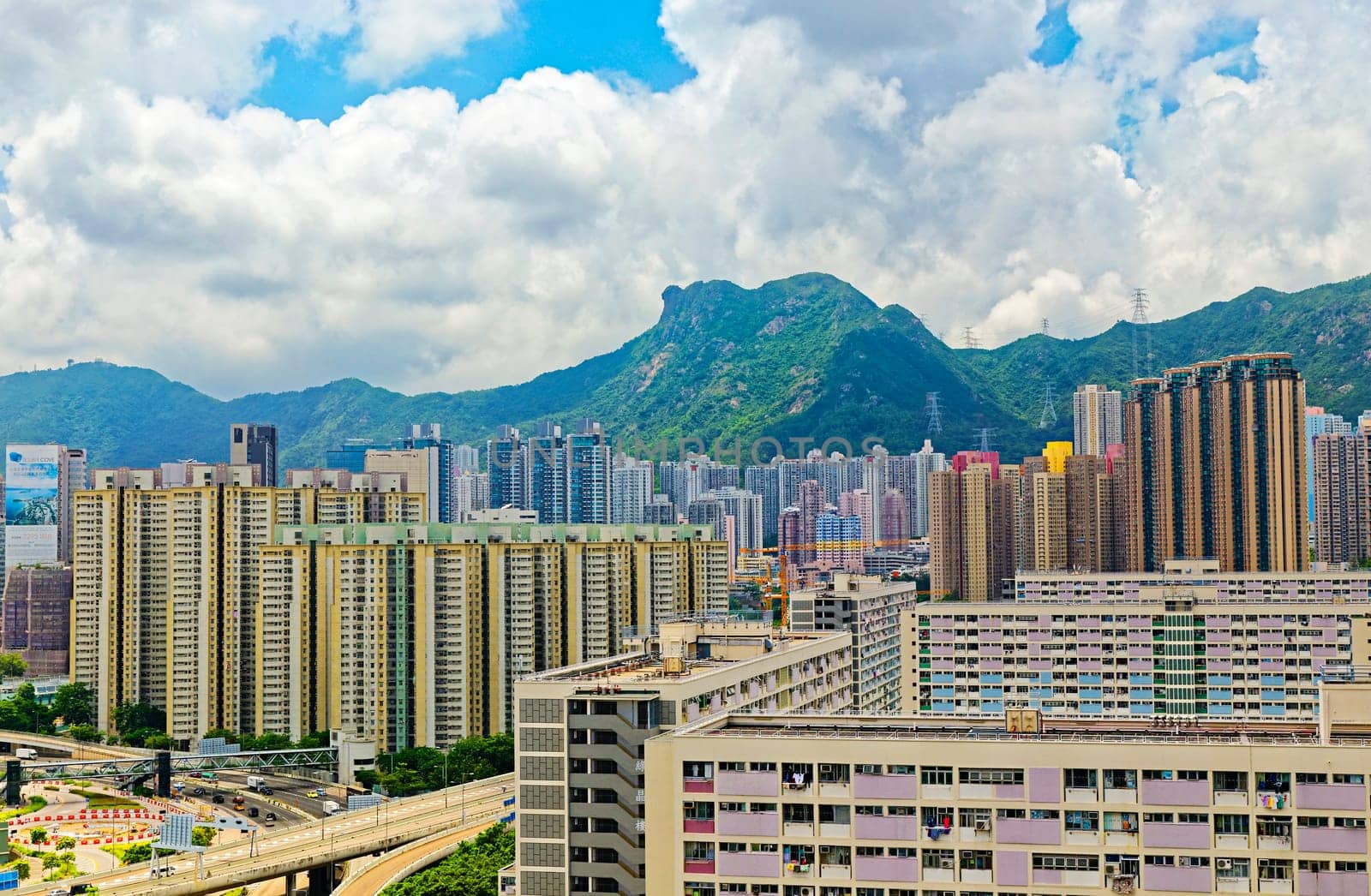 hong kong public estate buildings with landmark lion rock at day