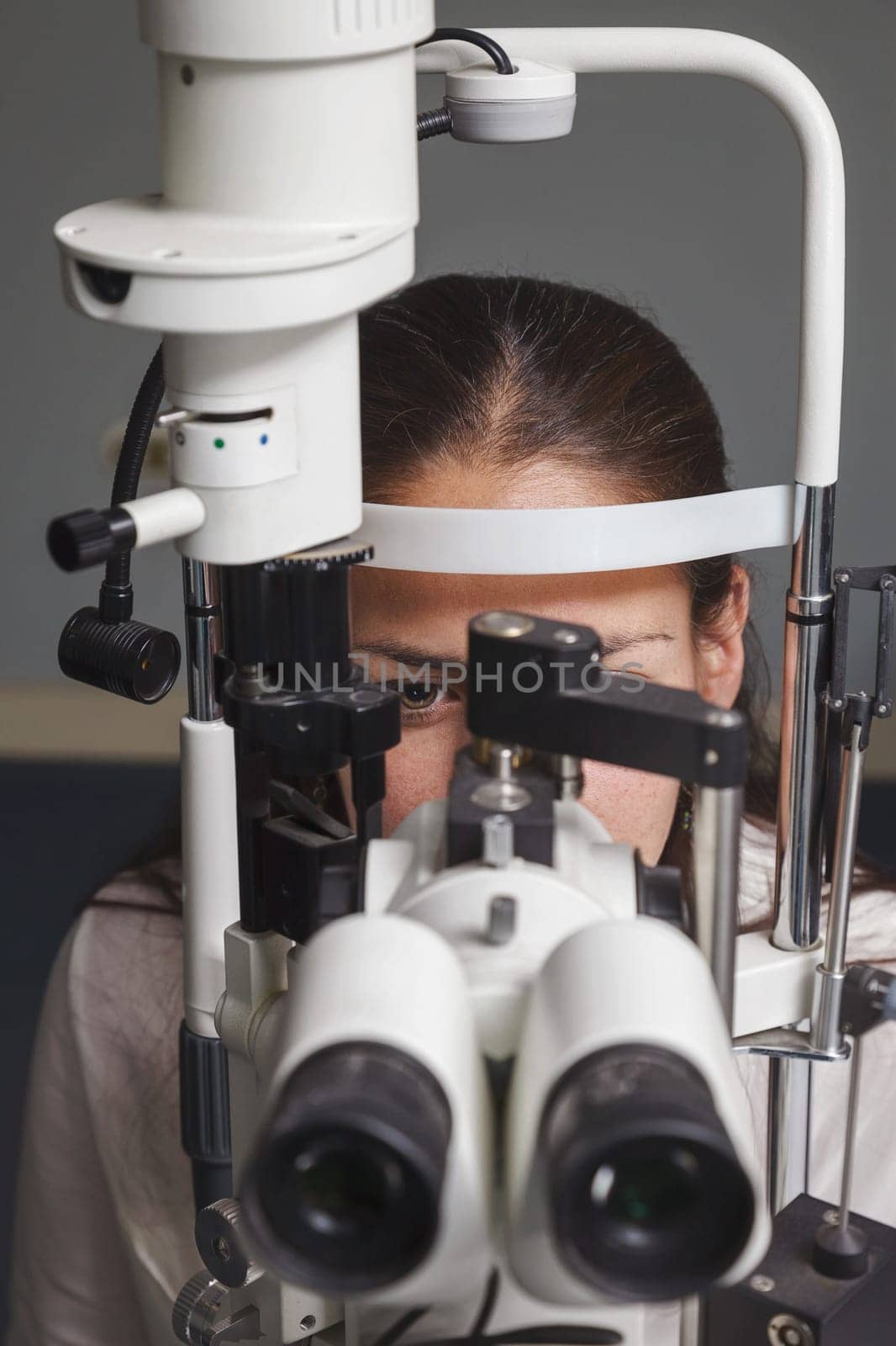 Beautiful young woman having eye test at the optometrist