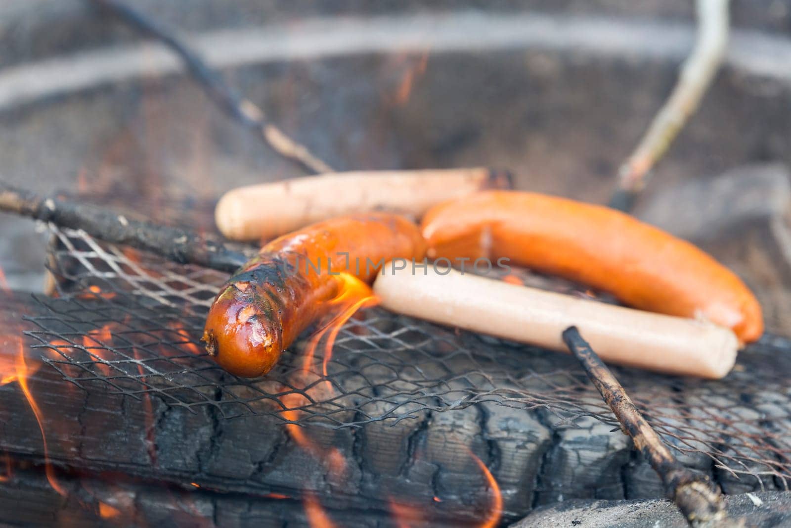 Sausage on Barbecue with Flames.