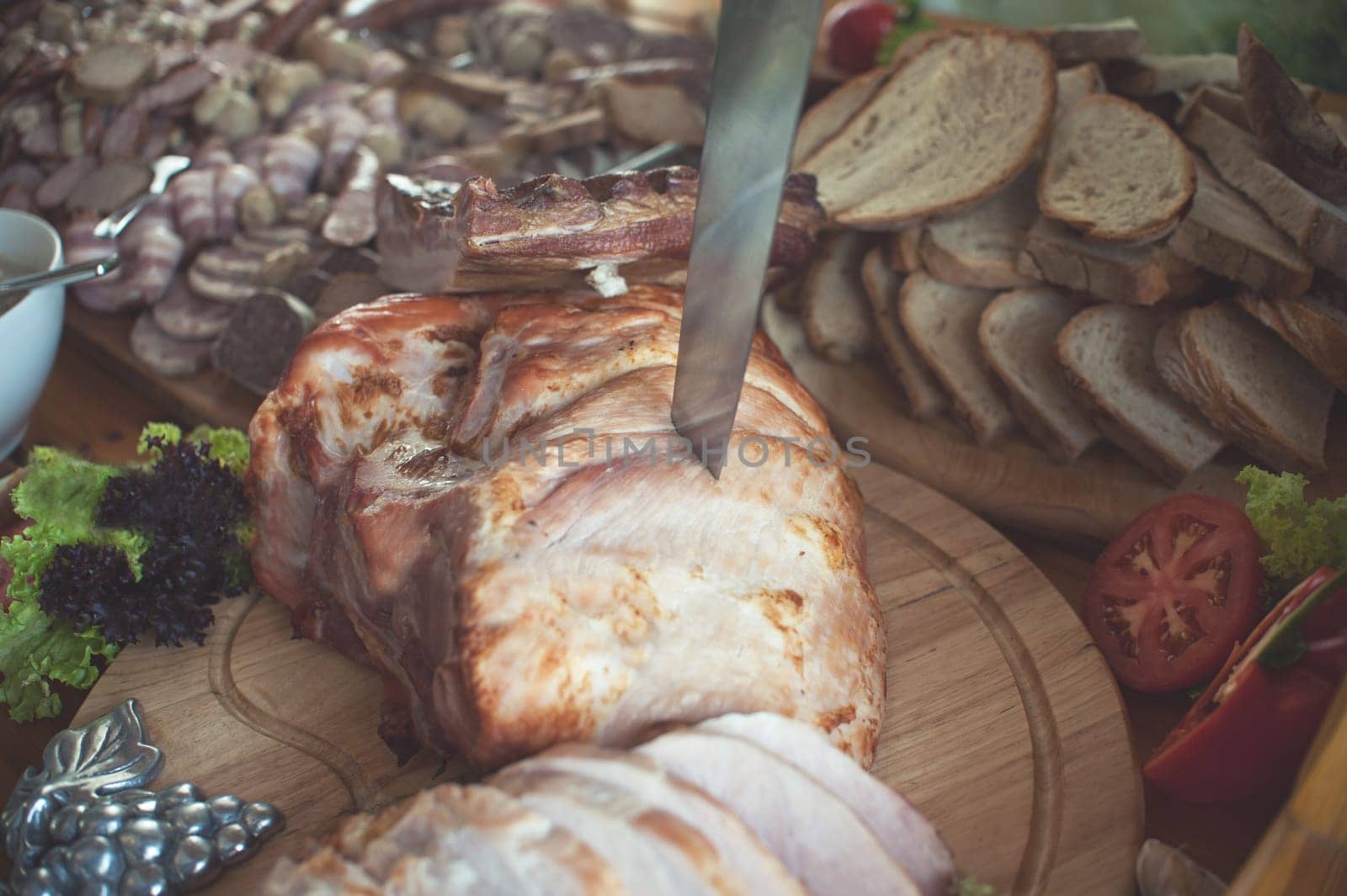 close up on baked ham in table with knife