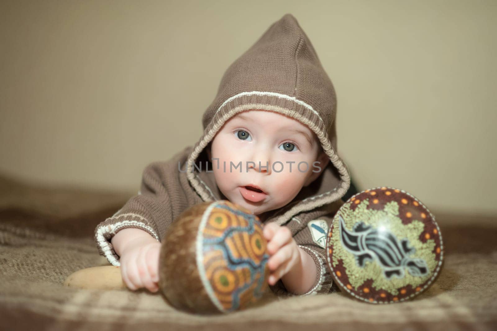 Cute baby playing on the bed, smiling and posing to the camera