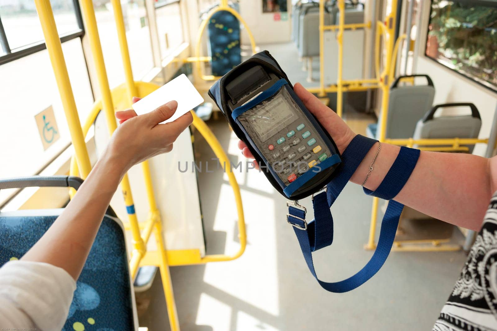 Human hand holding plastic cards. Passenger pays for the fare in public transport. Payment terminal, credit card reader, sales concept.