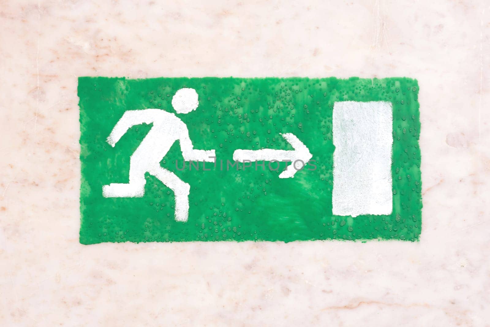 Emergency exit sign, green on a light background, visitor safety, the guests and participants