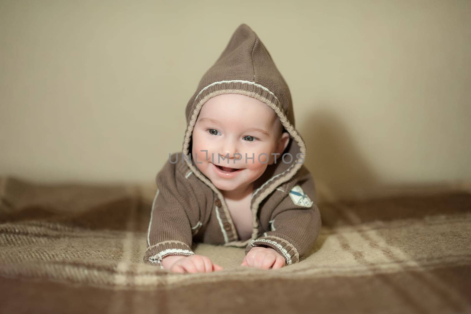 Cute baby playing on the bed, smiling and posing to the camera